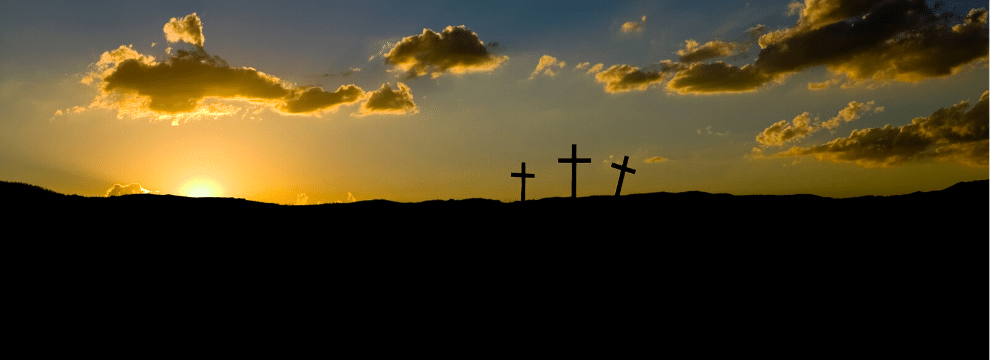 image of crosses in front of a sunrise